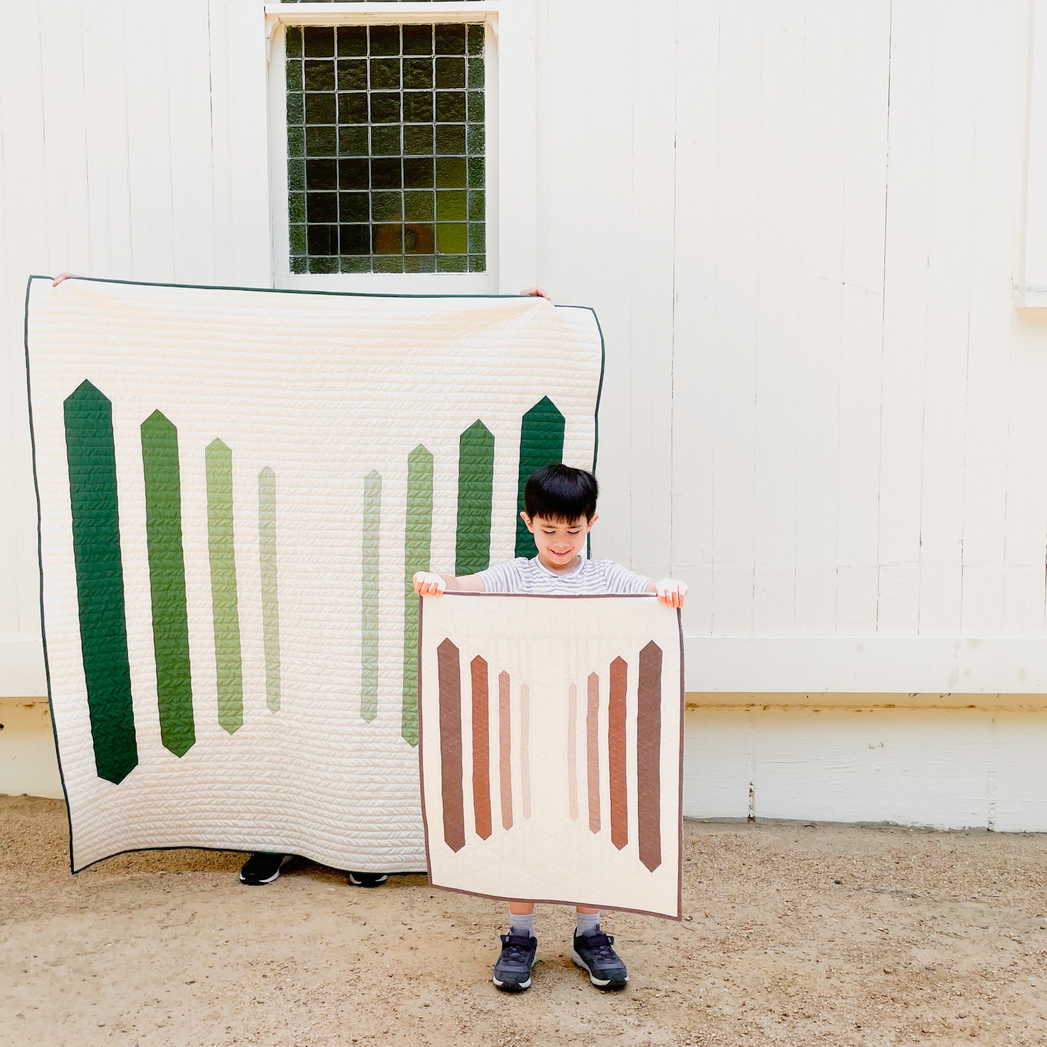 A throw size Pineknot Quilt and Wall Hanging Pineknot Quilt - a modern quilt pattern with a gradient of vertical stripes